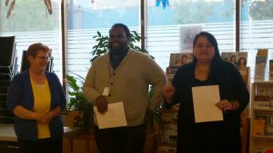 Orlando Mcleish (centre) stand with Loretta Jackson (left) and Vanessa West (right), executive director of Positive Living North