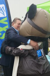 Rosenau Transport CEO Carl Rosenau embraces Amelia Bearheart