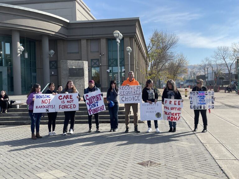 Community members stand against involuntary care outside Prince George Courthouse